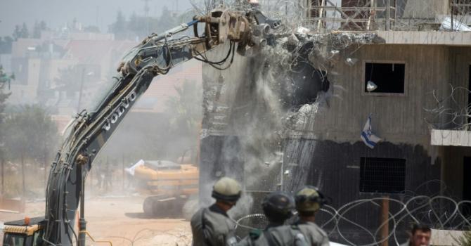 Israeli bulldozers start the demolition of the so-called Dreinoff buildings in the West Bank settlement of Beit El