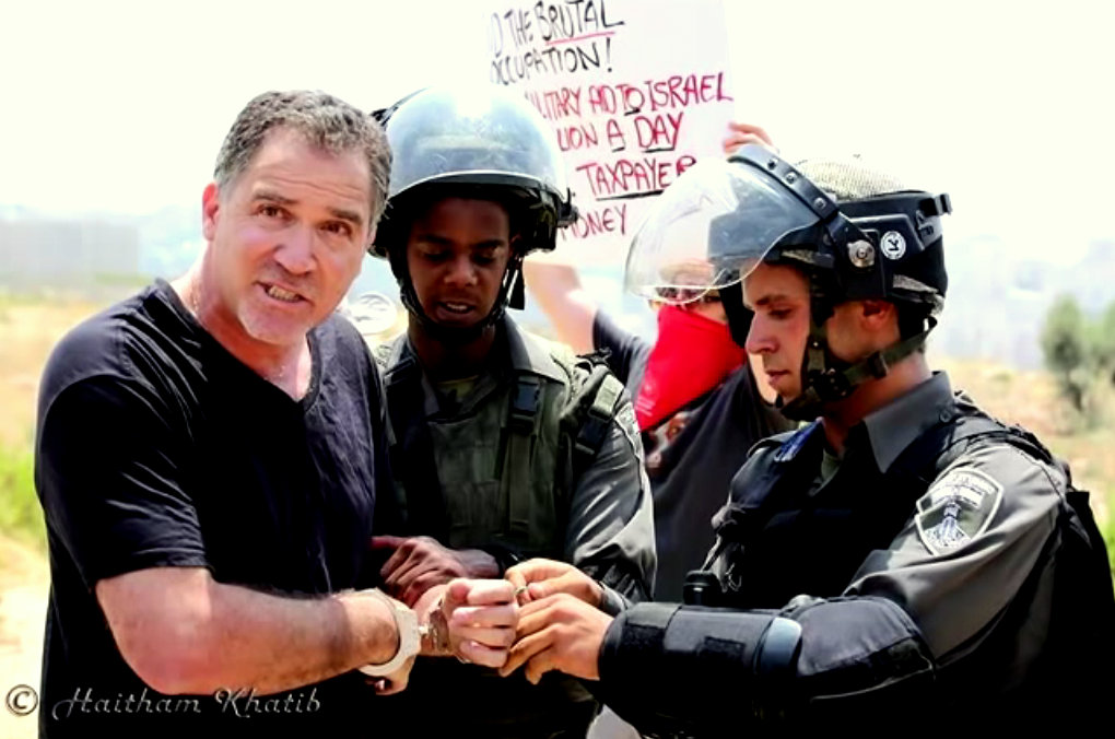 Israeli activist Mike Peled in handcuffs during a protest in Palestine