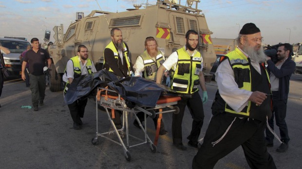 Israeli emergency services respond to an attack near the West Bank Gush Etzion settlements