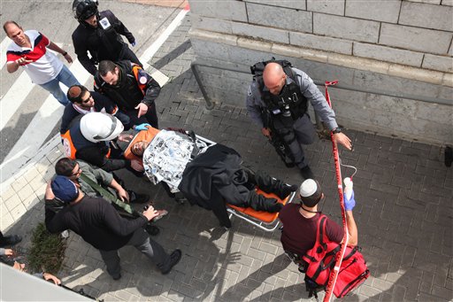 Israeli medics carry a wounded Israeli following a stabbing attack in a light rail train in Jerusalem Tuesday Nov. 10 2015. Israeli police say Palestinian assailants have attempted to carry out a pair of stabbing attacks on Israelis in Jerusalem on Tue