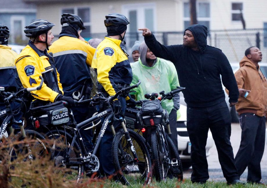 A protester has words with police officers during a Black Lives Matter protest at the Minneapolis Police Department’s 4th Precinct. It was the fourth day of protests over the killing of 24-year-old Jamar Clark