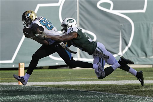 Jacksonville Jaguars wide receiver Allen Hurns crosses the goal line for a touchdown against New York Jets cornerback Antonio Cromartie during the second quarter of an NFL football game Sunday Nov. 8 2015 in East Rutherford N.J. (AP