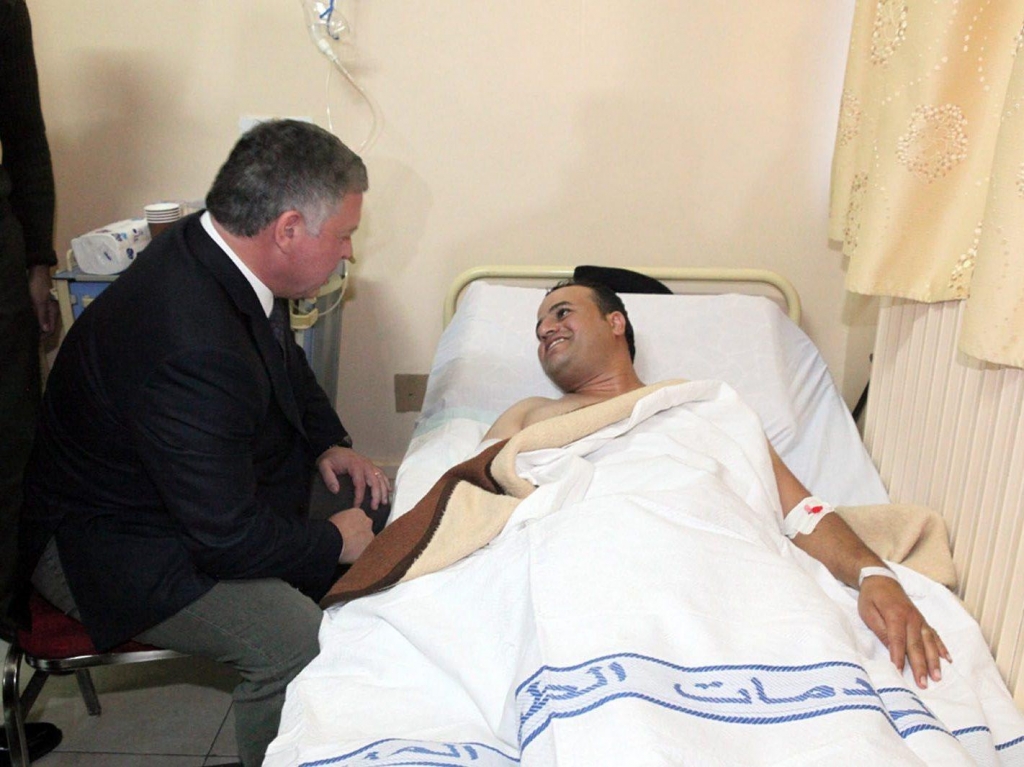 Jordan's King Abdullah II pays a hospital visit to people injured in Monday's shooting at a police training center