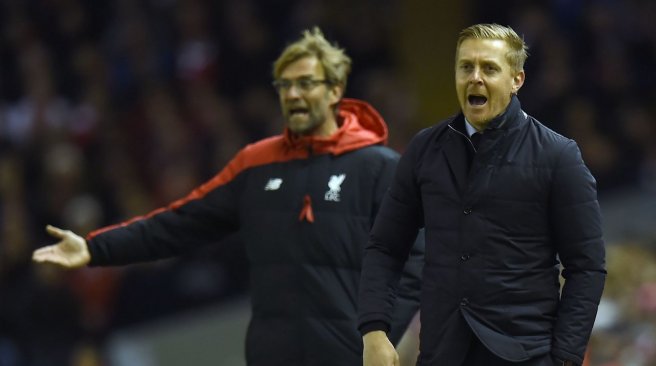 Liverpool manager Jurgen Klopp and Swansea City manager Garry Monk gesture from the touchline during the English Premier League football match between Liverpool and Swansea City at the Anfield stadium in Liverpool. AFP