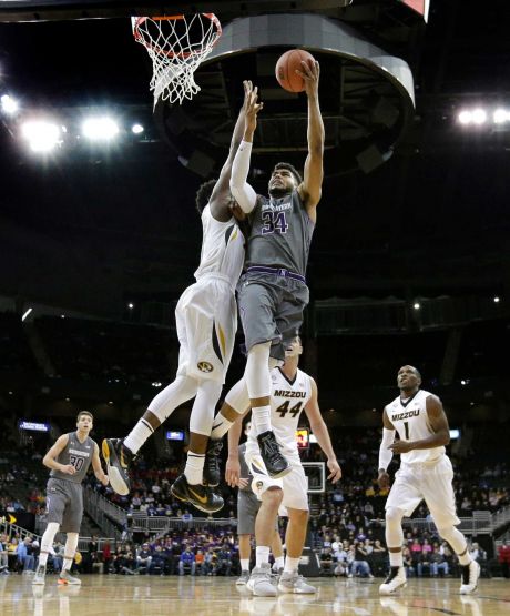 Northwestern's Sanjay Lumpkin shoots under pressure from Missouri's Namon Wright during the first half of an NCAA college basketball game Tuesday Nov. 24 2015 in Kansas City Mo