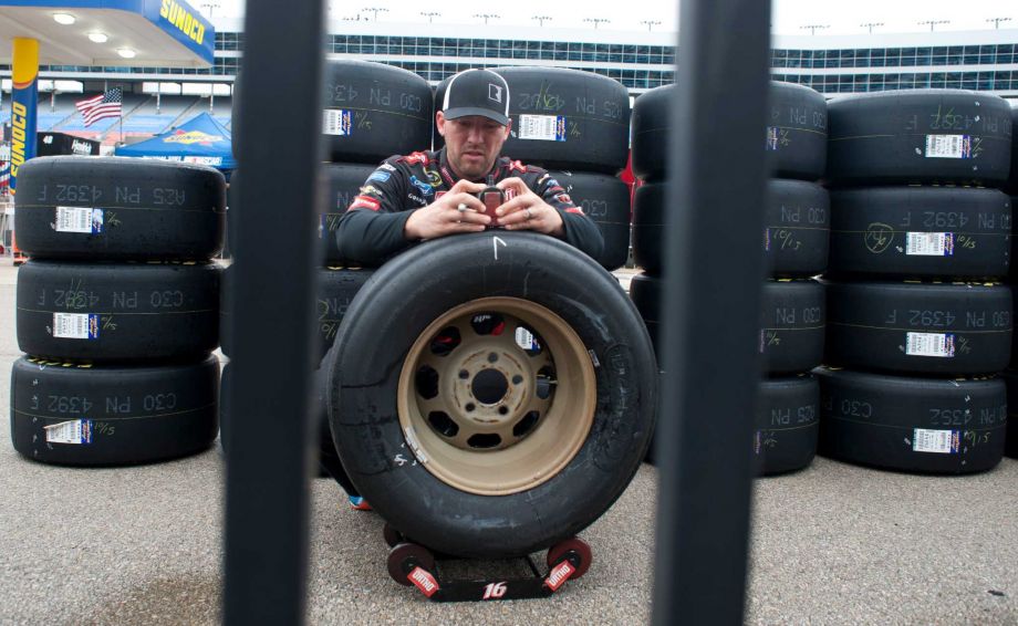 Dustin Keath checks tires for Sprint Cup Series driver Greg Biffle during a NASCAR auto race weather delay at Texas Motor Speedway Saturday Nov. 7 2015 in Fort Worth Texas. The morning and afternoon practice session were canceled