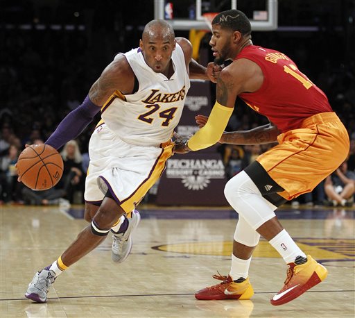 Los Angeles Lakers forward Kobe Bryant drives against Indiana Pacers forward Paul George right during the first half of an NBA basketball game in Los Angeles Sunday Nov. 29 2015