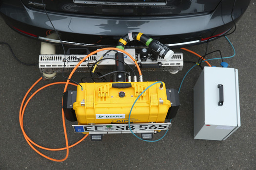 A PEMS device for testing the emissions of cars in real driving situations is seen attached to the exhaust pipe of a car during a workshop for media on automobile emissions at the DEKRA testing facility in Germany