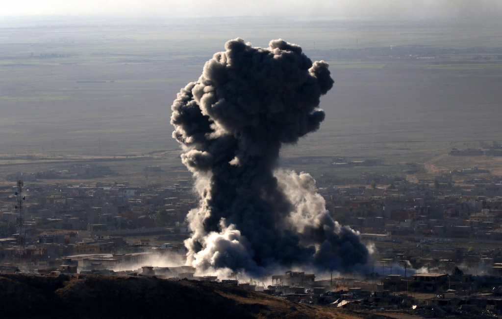 Heavy smoke billows during an operation by Iraqi Kurdish forces in the northern Iraqi town of Sinjar