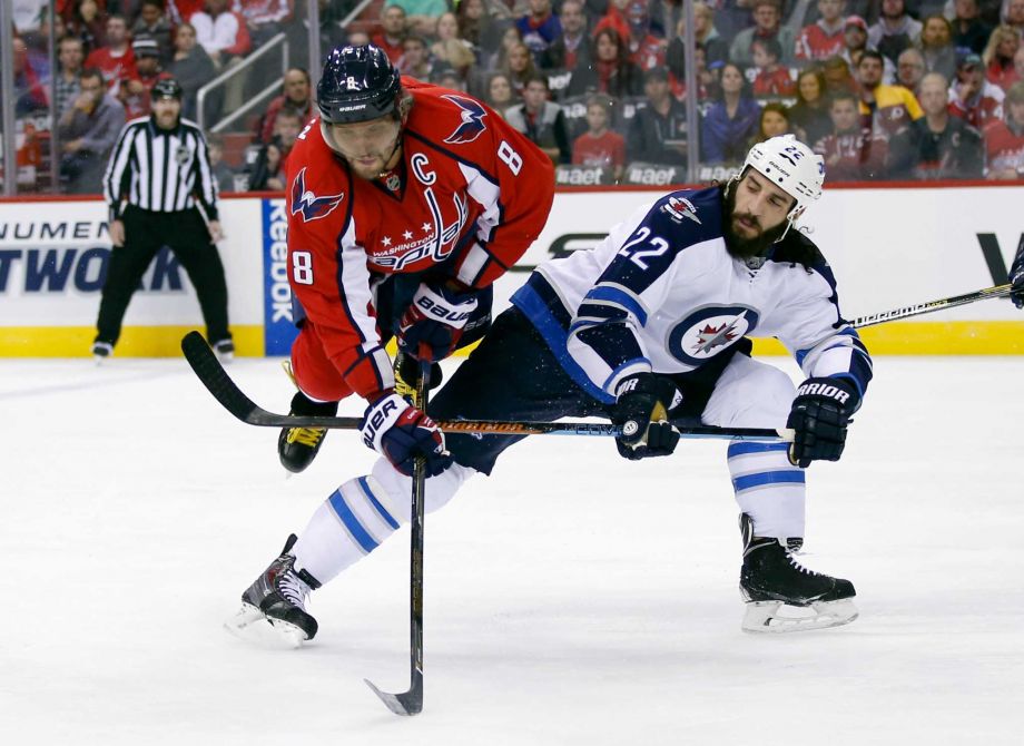 Washington Capitals left wing Alex Ovechkin, from Russia goes airborne over the leg of Winnipeg Jets right wing Chris Thorburn during the first period of an NHL hockey game Wednesday Nov. 25 2015 in Washington