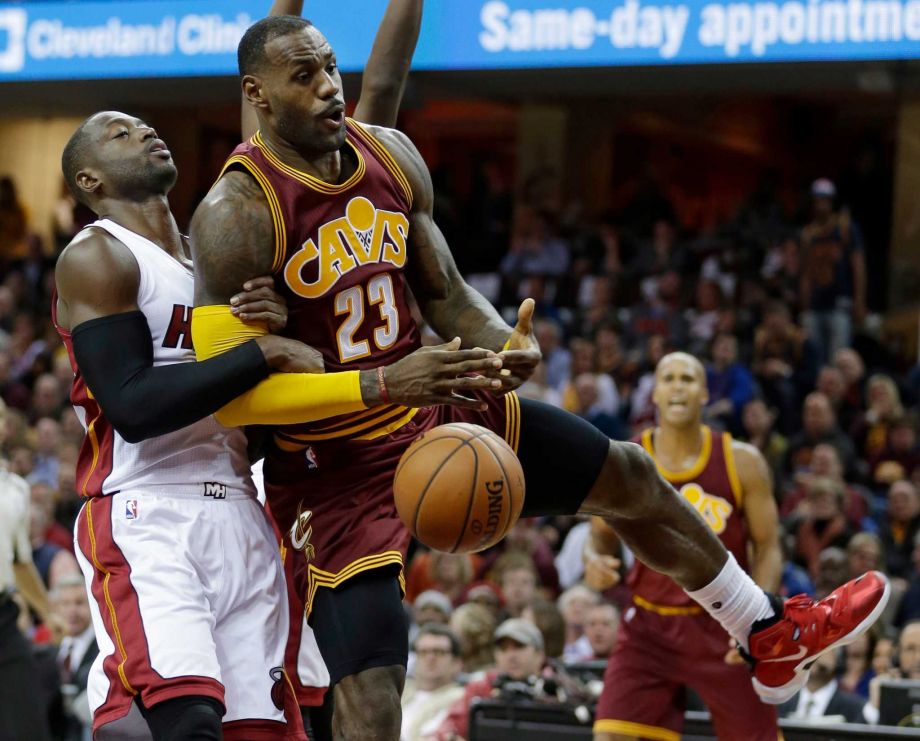 Miami Heat’s Dwyane Wade left fouls Cleveland Cavaliers Le Bron James during the second half of an NBA basketball game Friday Oct. 30 2015 in Cleveland. The Cavaliers won 102-92