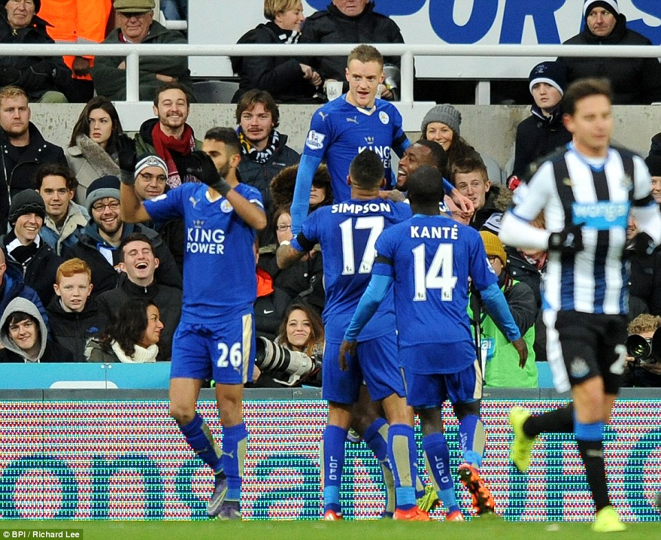 Leicester forward Jamie Vardy is mobbed by his team-mates after opening the scoring against Newcastle at St James Park