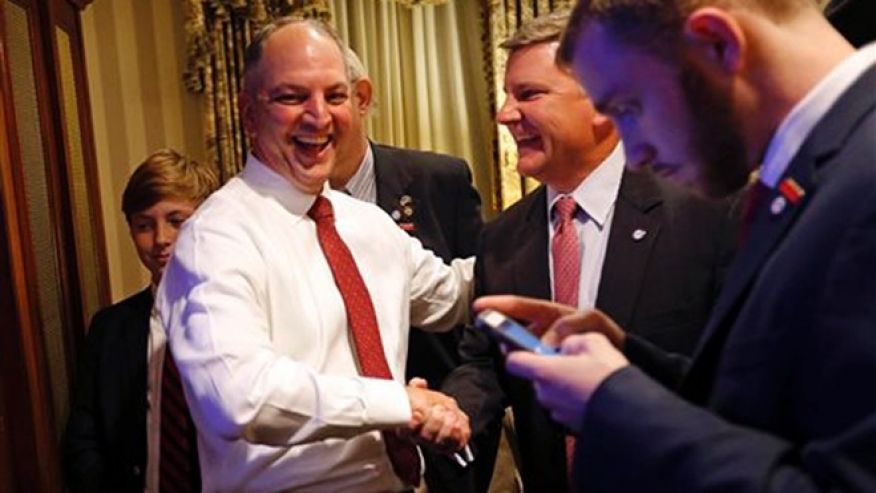 Louisiana Democratic gubernatorial candidate Rep. John Bel Edwards greets supporters as he watches election returns in a hotel suite at his election night watch party in New Orleans Saturday Nov. 21 2015