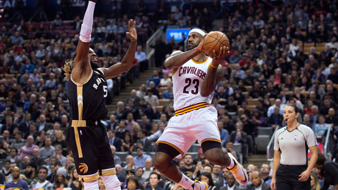 Cleveland Cavaliers&#039 Le Bron James right looks to pass as Toronto Raptors&#039 De Marre Carroll defends during the second half of an NBA basketball game Wednesday Nov. 25 2015 in Toronto