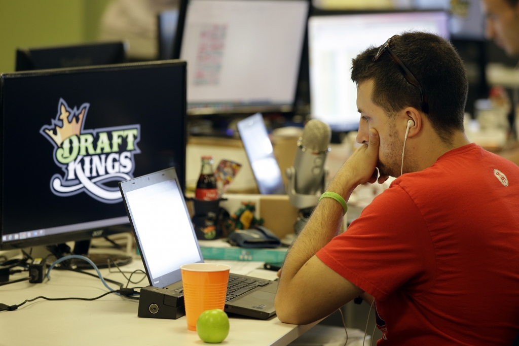 Devlin D'Zmura a tending news manager at DraftKings a daily fantasy sports company works on his laptop at the company's offices in Boston. Nevada has already decided daily fantasy sports are gambling