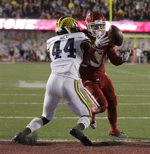 Indiana's Mitchell Paige is tackled by Michigan's Delano Hill as Paige tries to make a catch during double overtime of an NCAA college football game Saturday Nov. 14 2015 in Bloomington Ind. The pass was incomplete and Michigan defeated