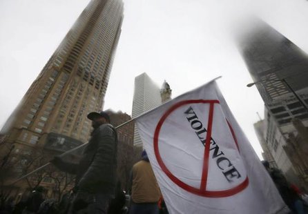 Demonstators gather to protest last year's shooting death of black teenager Laquan Mc Donald by a white policeman and the city's handling of the case at an intersection in the downtown shopping district of Chicago Illinois