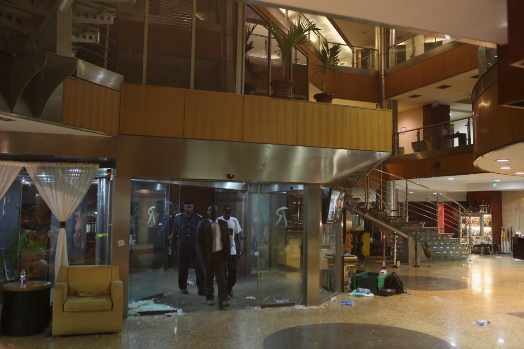 Malian officials enter the lobby of the Radisson hotel in Bamako Mali