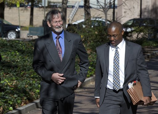 Douglas Hughes left who flew a gyrocopter through the National Mall before landing on Capitol Hill left arrives with his public defender Tony Miles for a plea hearing at the federal courthouse in Washington Friday Nov. 20 2015. Hughes is expected