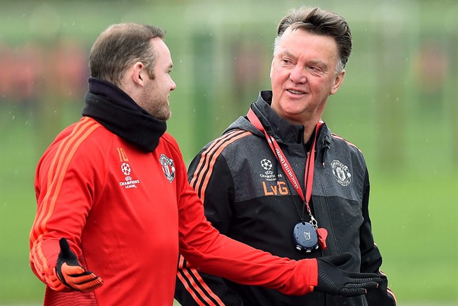 Manchester United manager Louis van Gaal right talks with Wayne Rooney during a training session at the team's training complex in Manchester England Tuesday Nov. 24 2015. United will play PSV Eindhoven in a Champions League soccer match on Wednersda