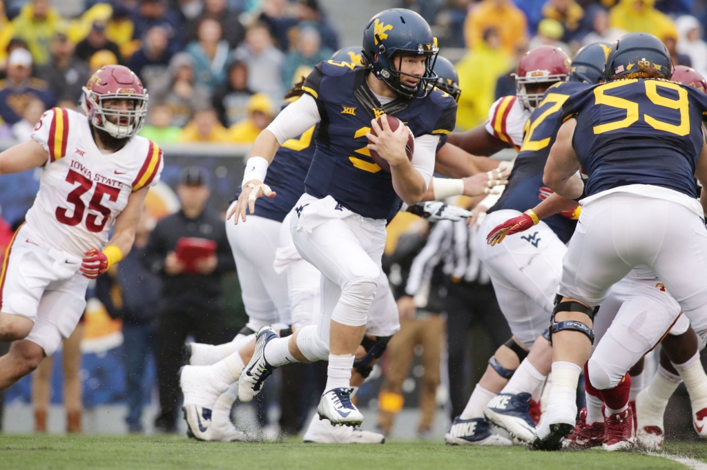 Iowa St West Virginia Football West Virginia quarterback Skyler Howard carries the ball during the first half Saturday against Iowa State in Morgantown