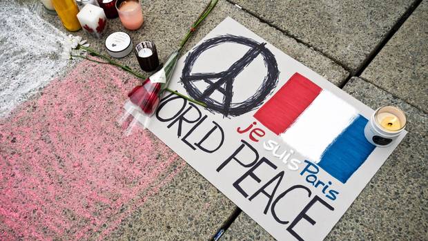 People left cards candles and flowers at a vigil at Nathan Phillips Square in Toronto to commemorate the victims of the Paris attacks on Nov. 14 2015