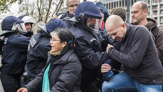 Riot police remove counter-protesters opposing a demonstration of the right-wing populist Alternative for Germany party in Berlin