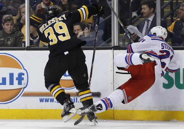 Derek Stepan is hit by Bruins forward Matt Beleskey in the second period and is unable to return