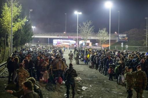 Migrants wait to cross the Slovenian Austrian border from the Slovenian city of Sentilj