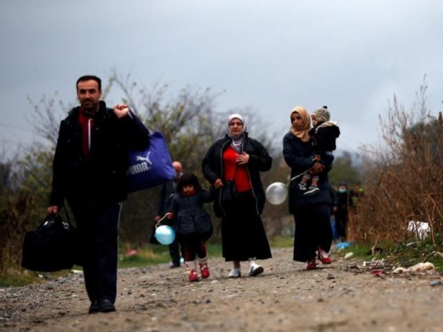 Migrants walk after crossing the border from Greece into Macedonia near Gevgelija Macedonia