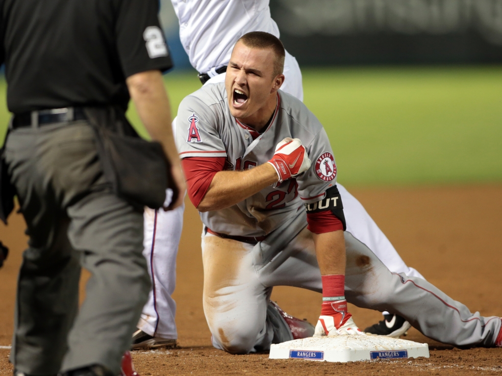 Mike Trout reacts after hitting a triple in the ninth inning against the Texas Rangers this season