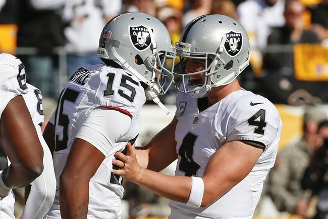 Oakland Raiders wide receiver Michael Crabtree and quarterback Derek Carr celebrate a touchdown pass in the first quarter of an NFL football game against the Pittsburgh Steelers Sunday Nov. 8 2015 in Pittsburgh