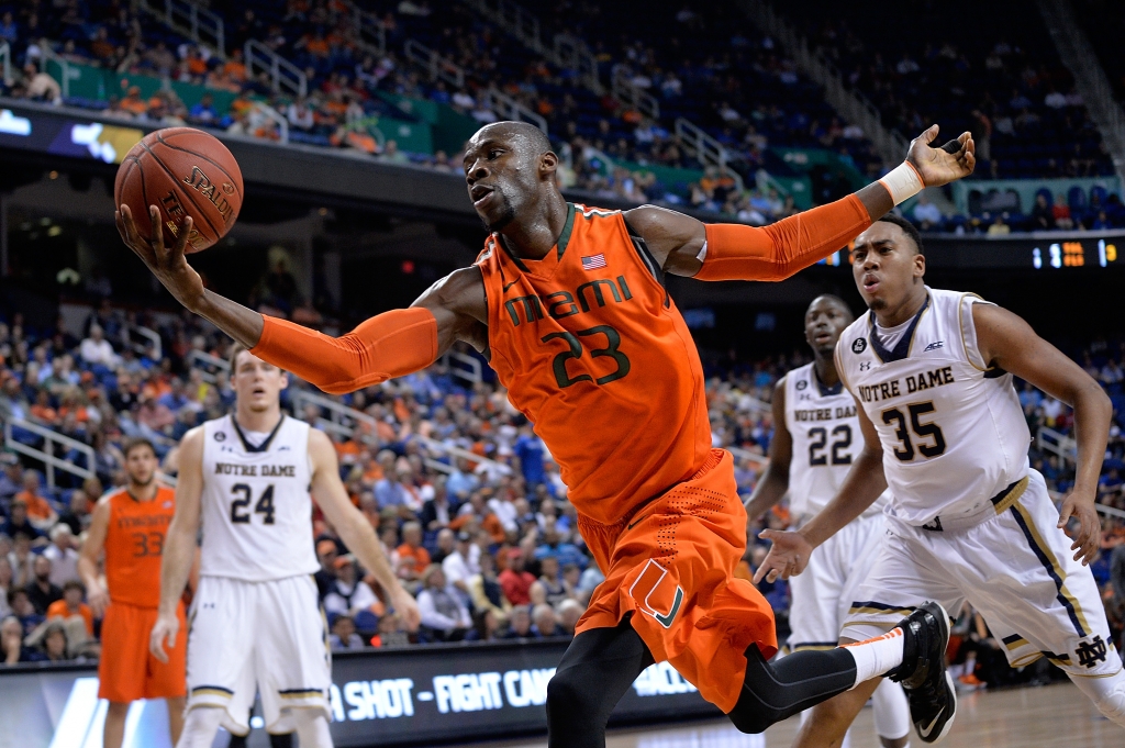 Tonye Jekiri #23 of the Miami Hurricanes tracks down a loose ball on the end line against the Notre Dame Fighting Irish during the quarterfinals of the ACC Basketball Tournament at Greensboro Coliseum