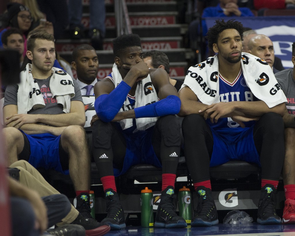 HILADELPHIA PA- OCTOBER 30 Nik Stauskas #11 Nerlens Noel #4 and Jahlil Okafor #8 of the Philadelphia 76ers watch the final minutes of the game against the Utah Jazz from the bench