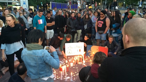 More than 100 people gathered in Auckland's Aotea Square to express support for the French people