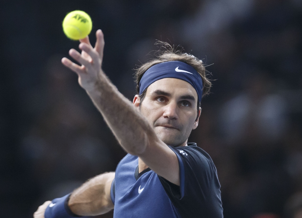 Switzerland's Roger Feder serves the ball to American's John Isner during their third round match of the BNP Masters tennis tournament at the Paris Bercy Arena in Paris France Thursday Nov. 5 2015. AP