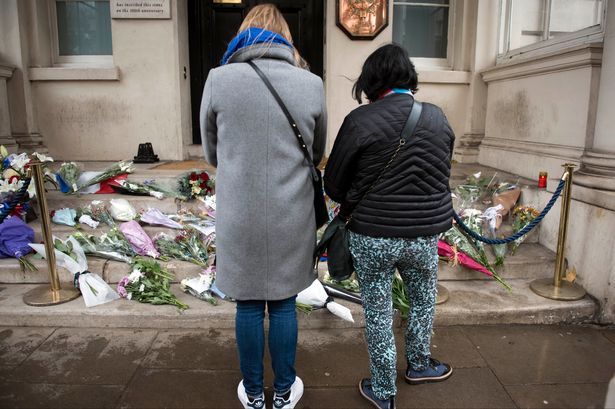 People pay their respects by leaving flowers outside of the French Embassy in London after terror attacks killed at least 127 people in Paris last night. PRESS ASSOCIATION