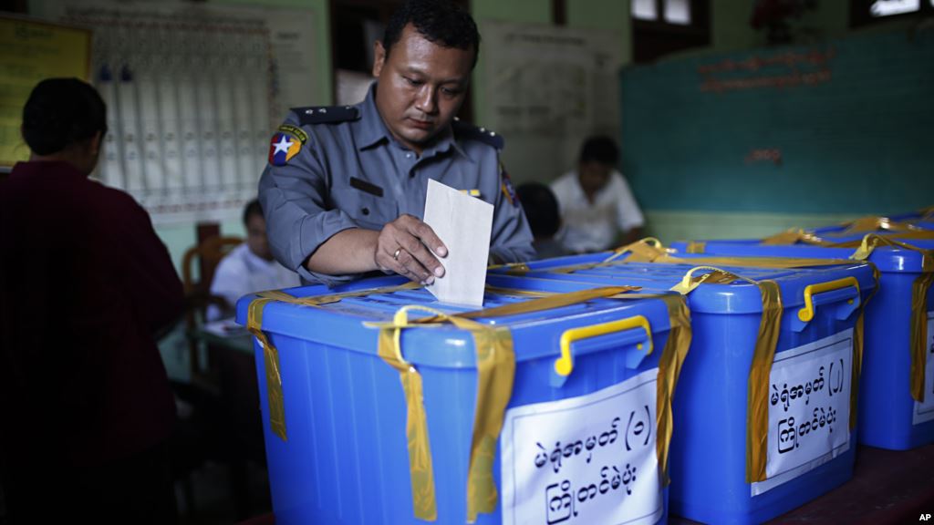 A police officer casts his vote in advance for upcoming Nov. 8 general election at a township Election Commission Office in Mandalay Myanmar Nov. 6 2015