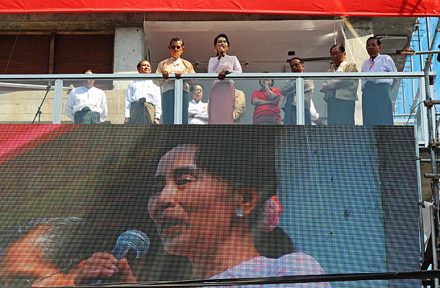 Kyi, flanked by party patron Tin Oo and other party officials delivers a speech from the balcony of the National League of Democracy headquarters in Yangon Burma