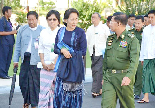 NLD leader Daw Aung San Suu Kyi walks with Commander-in Chief U Min Aung Hlaing in October 2014