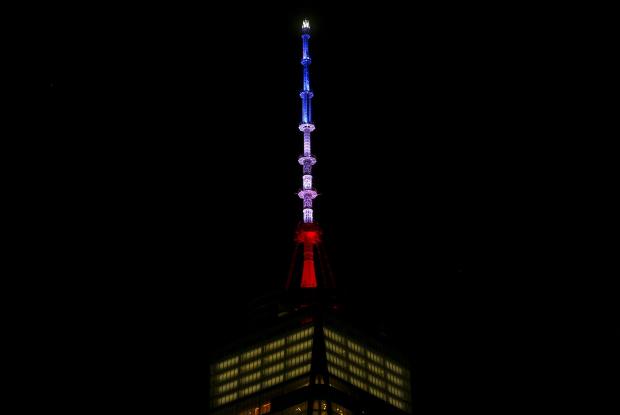 One World Trade Center is lit in the Blue White and Red colors of the French flag in honor of the victims of the attacks in Paris in the Manhattan borough of New York