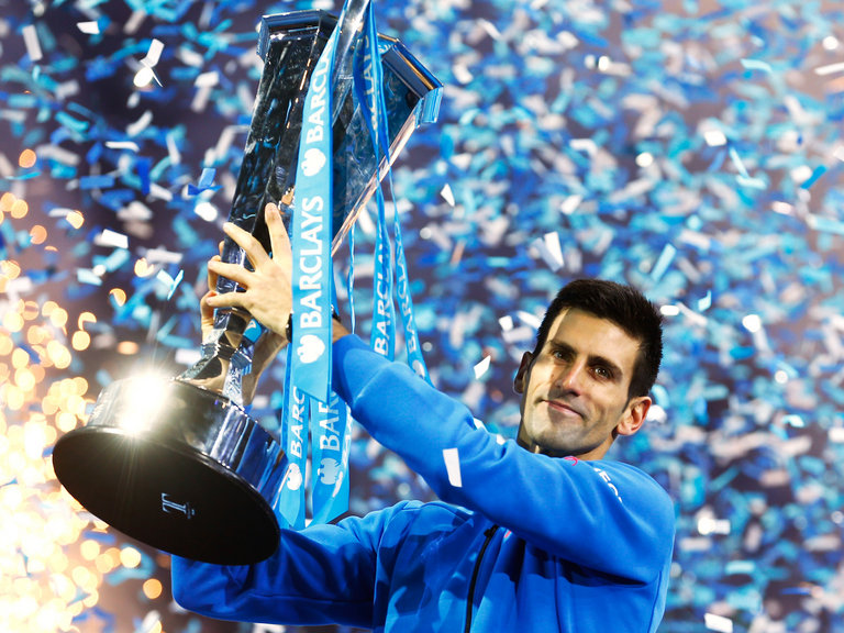 Novak Djokovic lifts the ATP World Tour Finals trophy aloft