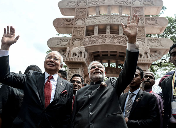 Modi and Najib wave after inaugurating the ‘Torana Gate’ symbolising Malaysia India relations at Brickfields popularly known as Little India in Kuala Lumpur. — AFP