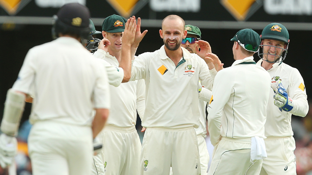 Nathan Lyon congratulated by teammates on taking a wicket