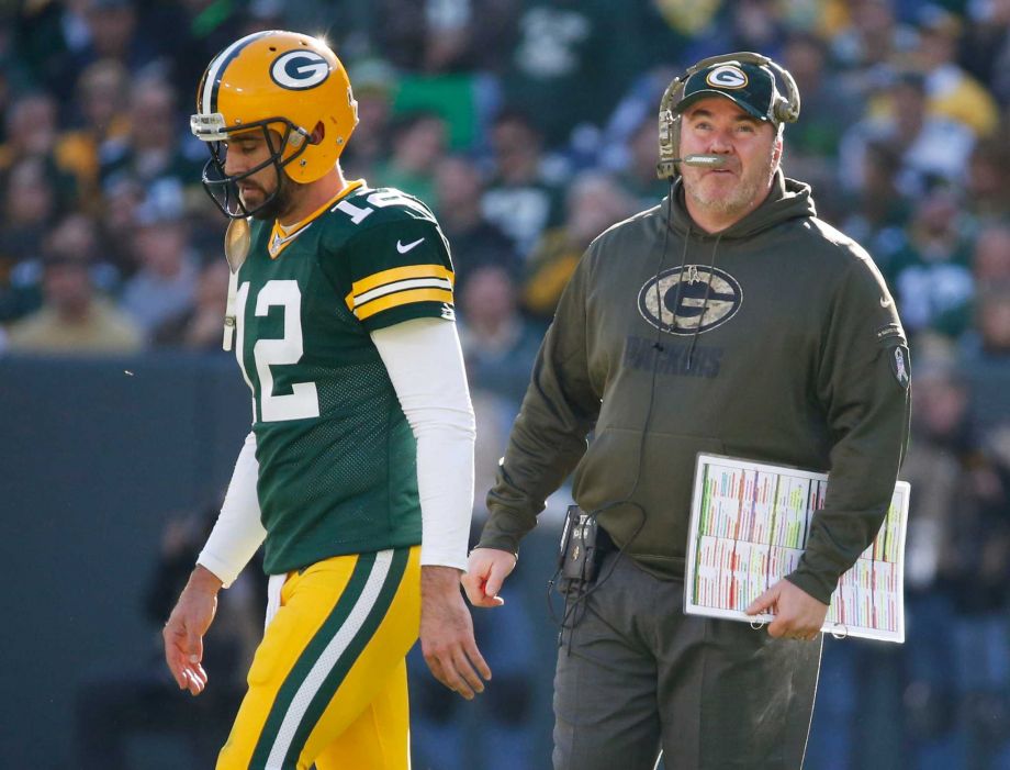 Green Bay Packers head coach Mike Mc Carthy talks to quarterback Aaron Rodgers during the first half of an NFL football game against the Detroit Lions Sunday Nov. 15 2015 in Green Bay Wis