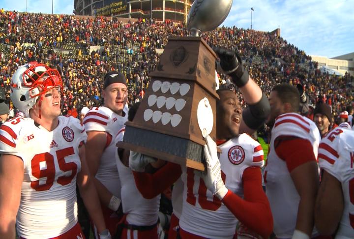 Nebraska holds the Heroes Trophy after beating Iowa 37-34 in overtime in 2014