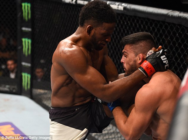 Magny who controlled the first three rounds lands a knee on Kelvin Gastelum from the clinch