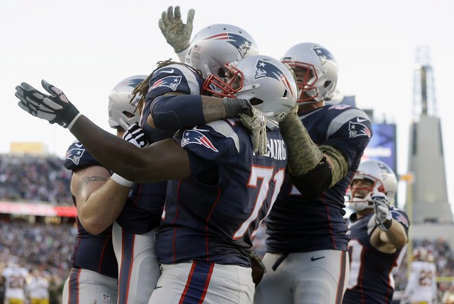 New England Patriots running back Brandon Bolden celebrates with guard Cameron Fleming after scoring a touchdown in against the Washington Redskins during the second half of an NFL football game Sunday Nov. 8 2015 in Foxborough Mass. (AP