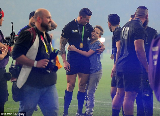 New Zealand centre Sonny Bill Williams hugs young supporter Charlie Lines after the World Cup final win