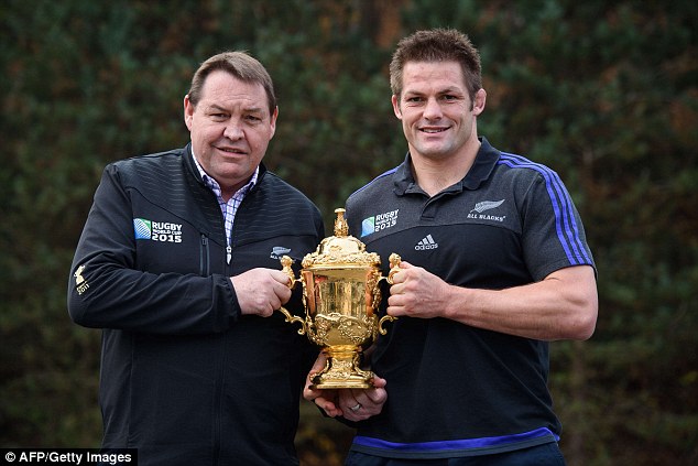 New Zealand coach Steve Hansen poses with the Webb Ellis Cup with captain Richie Mc Caw on Sunday